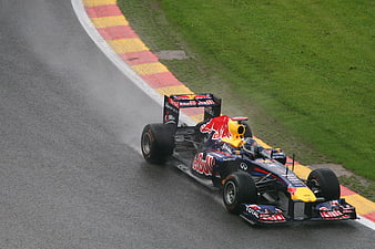 Red Bull Formula 1 Car Racing on Wet Track