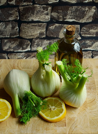 Fresh Fennel Bulbs and Lemon Slices on Wooden Board