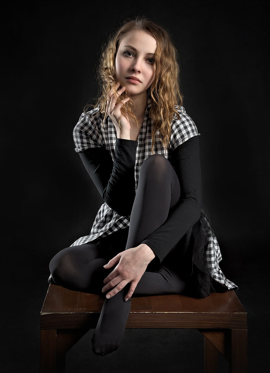 Studio Portrait of Young Woman in Black Tights and Checkered Shirt