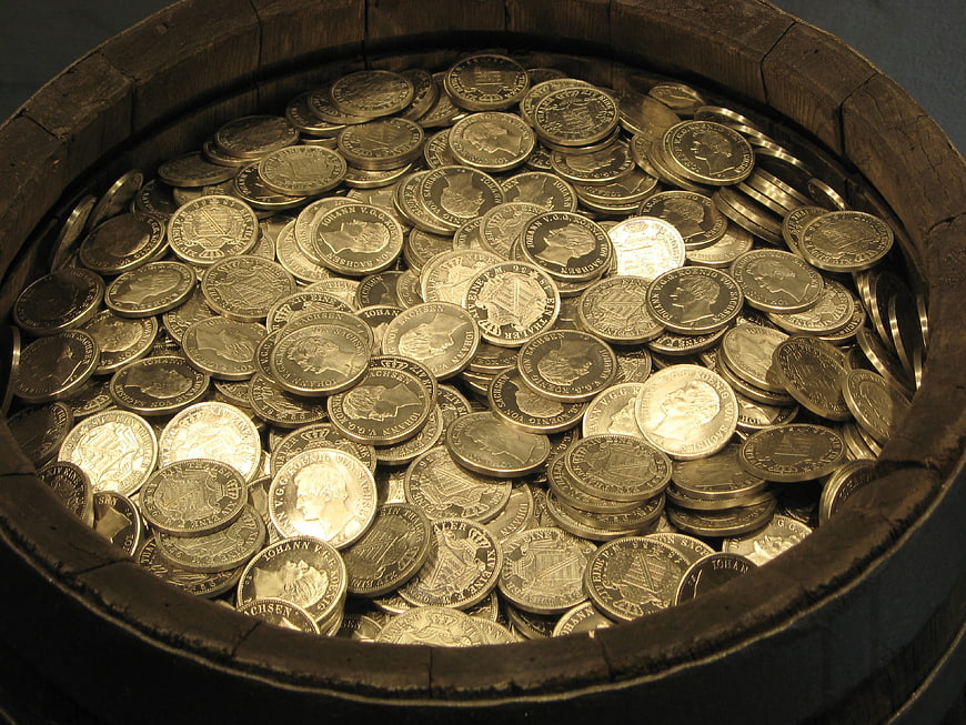 Wooden barrel filled with old silver coins