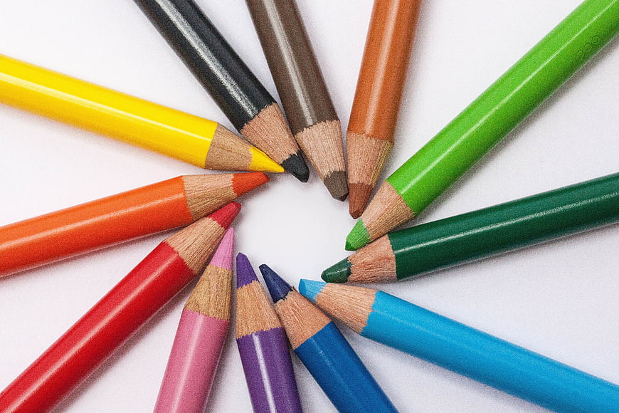 Multicolored Pencils Arranged in a Circle on White Background