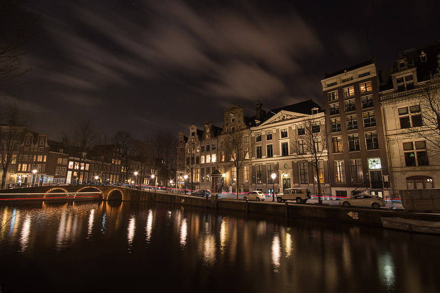 Night cityscape of Amsterdam canal with long exposure reflections