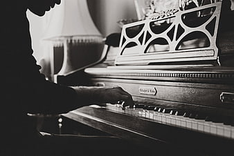 Man Playing Vintage Piano in Black and White