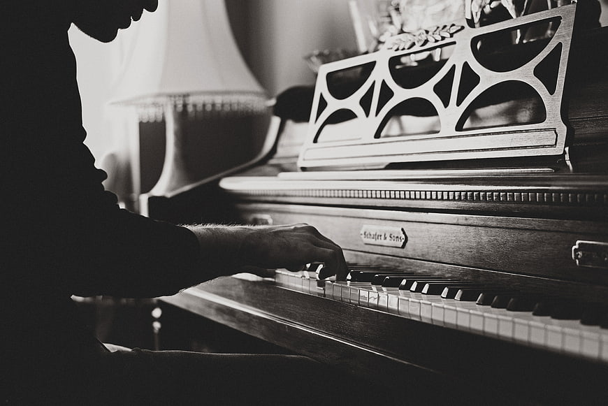 Man Playing Vintage Piano in Black and White