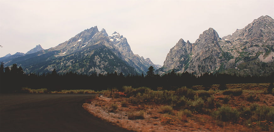 Winding Road Leading to Majestic Mountain Peaks
