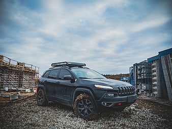 Black SUV with Roof Rack on Gravel Construction Site