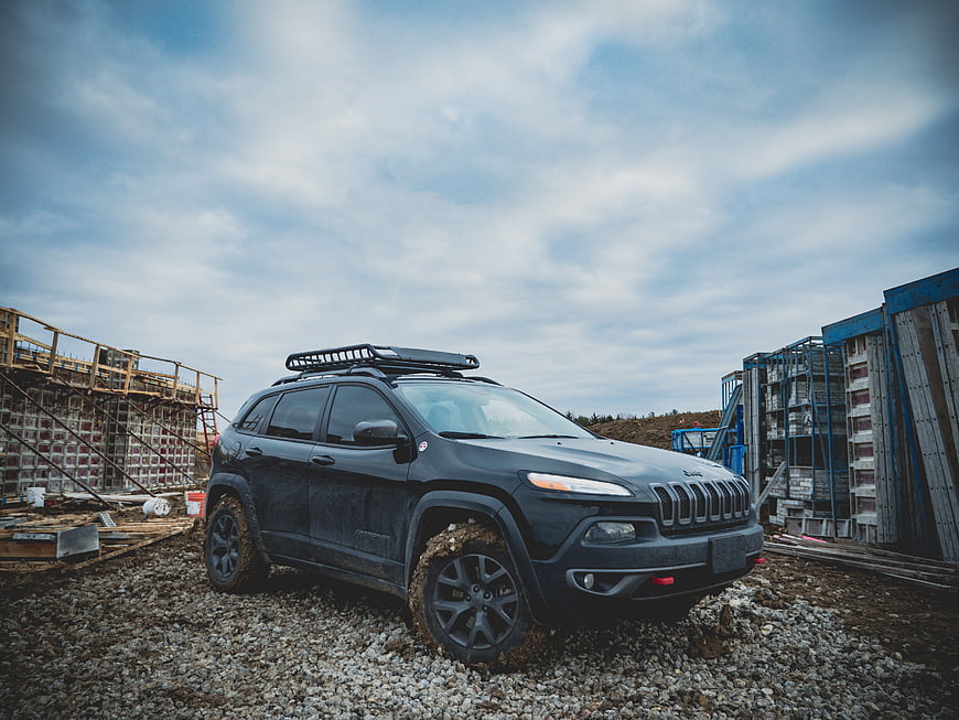 Black SUV with Roof Rack on Gravel Construction Site