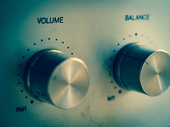 Close-up of vintage audio amplifier volume and balance control knobs