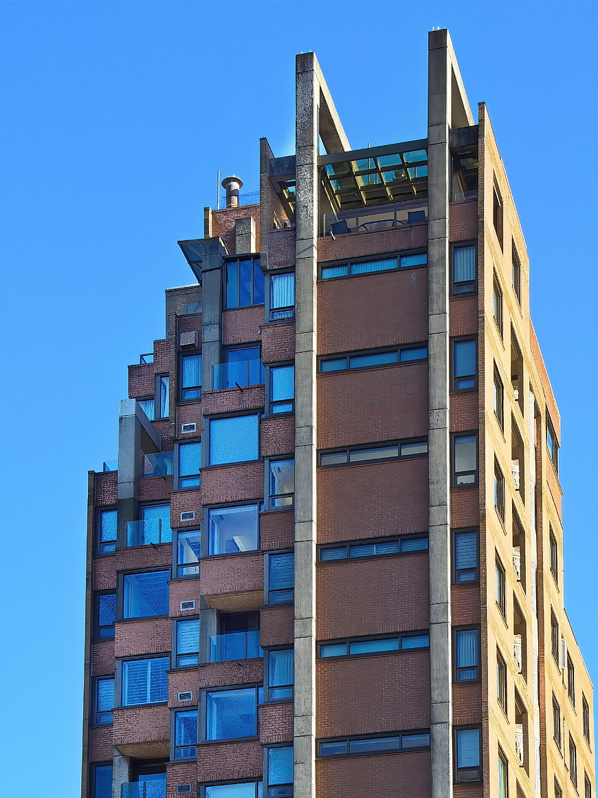 Modern Brick Apartment Building Facade Against Blue Sky