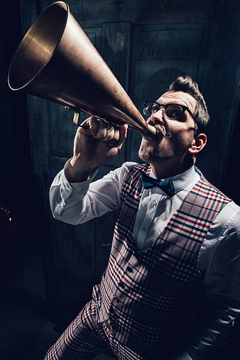 Man in vintage plaid suit blowing brass horn