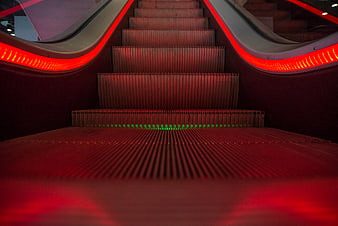 Red LED illuminated escalator steps with perspective view