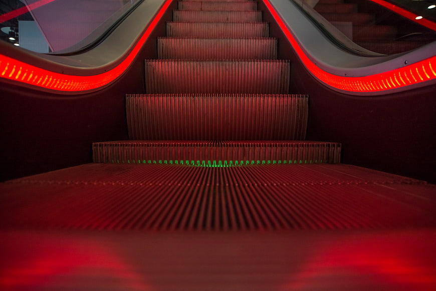 Red LED illuminated escalator steps with perspective view