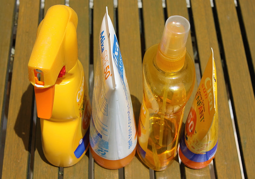 Assorted Sunscreen Products on Wooden Deck