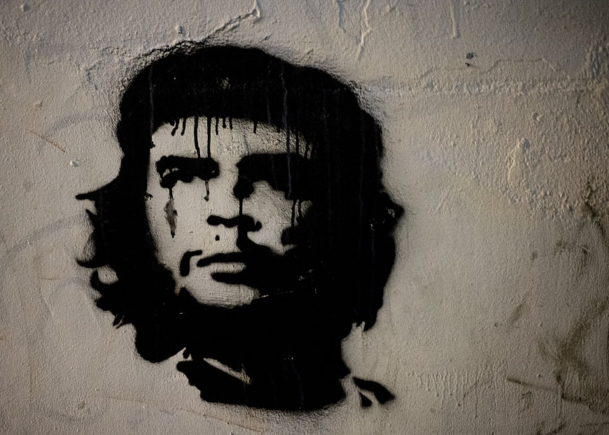 Black and white Che Guevara graffiti mural on textured wall