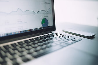 Laptop displaying analytics charts and graphs on screen