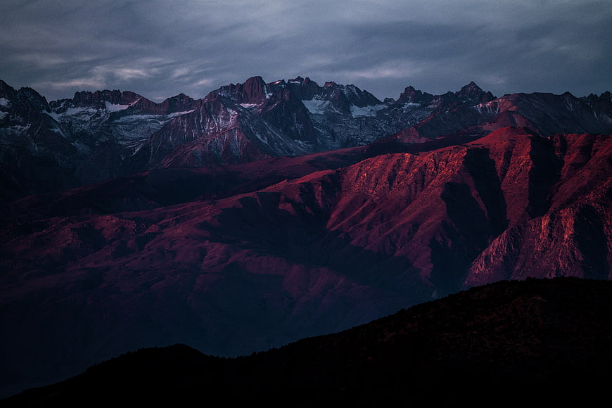 Dramatic Mountain Landscape with Red Alpenglow and Snowy Peaks