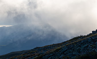 Misty Mountain Ridge with Rocky Terrain and Clouds