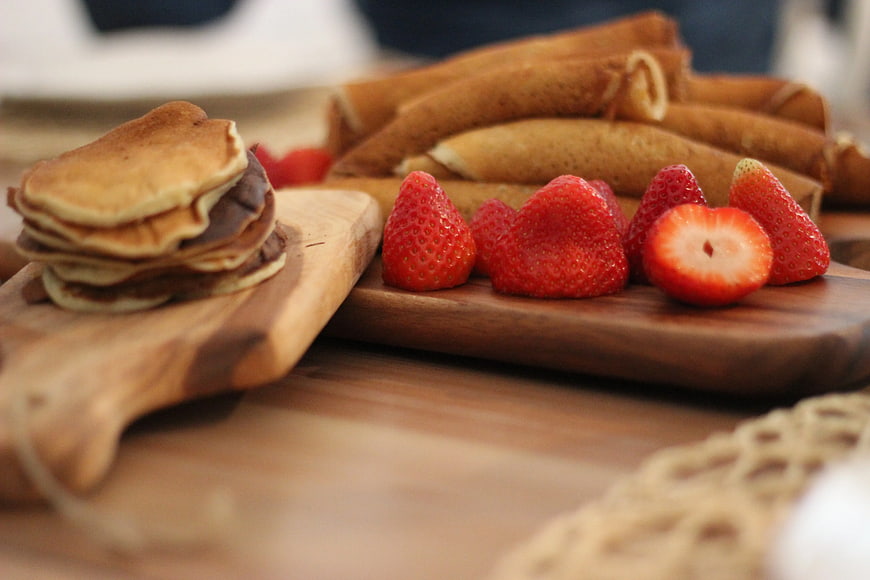 Fresh Strawberries and Pancakes on Wooden Board