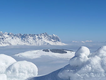 Snowy Mountain Peaks Above Sea of Clouds
