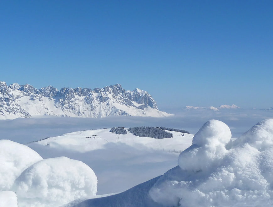 Snowy Mountain Peaks Above Sea of Clouds