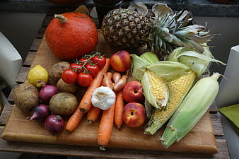 Fresh Harvest Vegetables and Fruits on Wooden Board