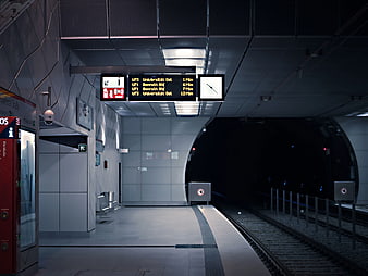 Empty modern subway station platform with digital departure board