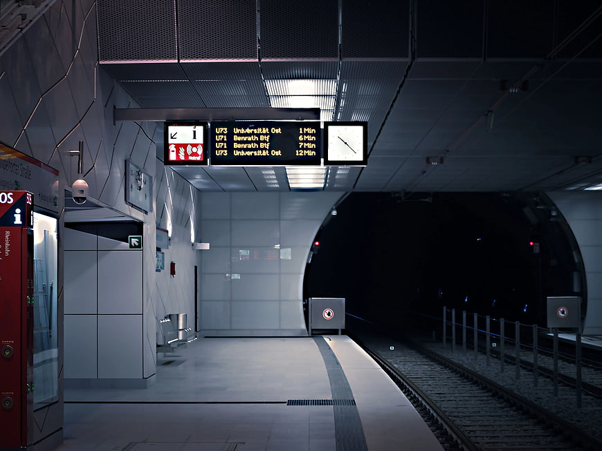 Empty modern subway station platform with digital departure board