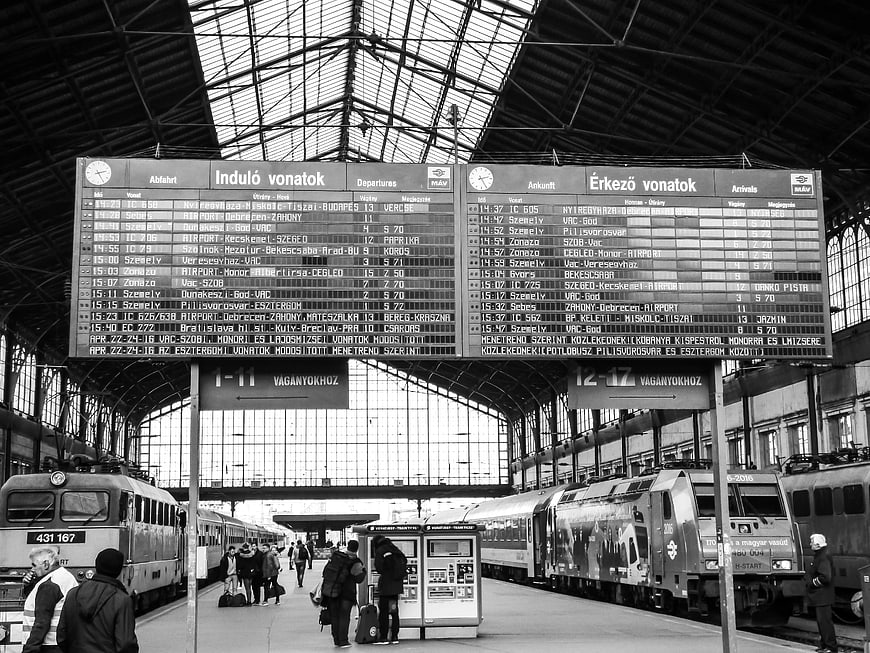 Black and white train station departure board with trains