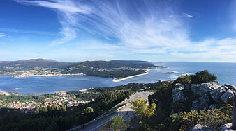 Panoramic View of Coastal Town and Ocean from Hilltop