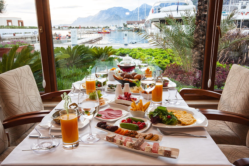 Luxury breakfast spread with harbor and mountain view