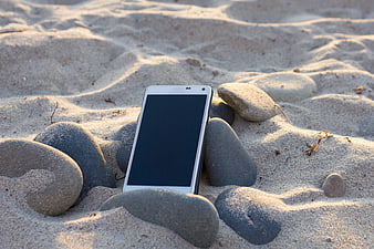 White Smartphone Mockup Leaning on Beach Stones