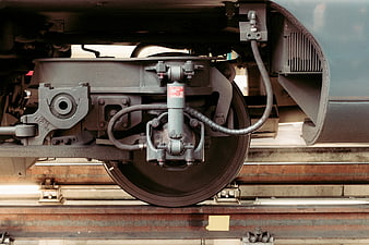 Close-up of train wheel and brake assembly on railway track