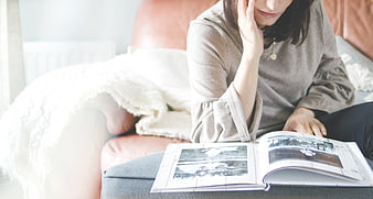 Woman Reading Magazine on Couch with Blanket