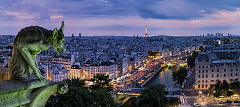Gargoyle overlooking Paris cityscape at dusk with Eiffel Tower