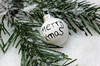 White Merry Xmas Ornament on Snowy Pine Branch