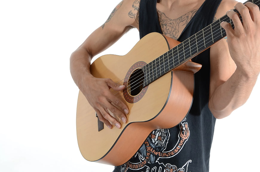 Man Playing Acoustic Guitar with Tattoos