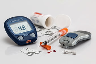 Diabetes management supplies with glucose meter and insulin syringe