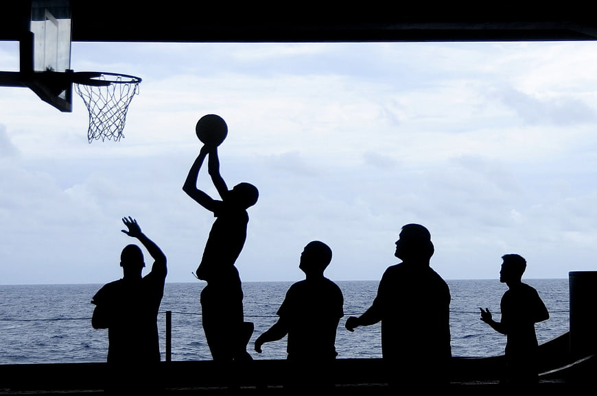 Silhouette of Men Playing Basketball by the Sea