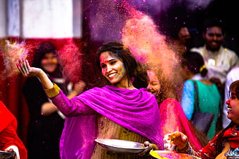 Woman Throwing Colorful Powder During Holi Festival Celebration