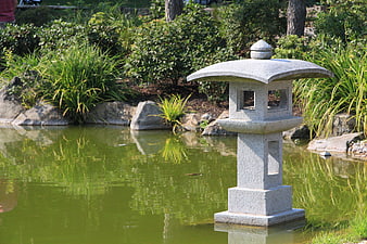 Stone Japanese Lantern in Serene Garden Pond