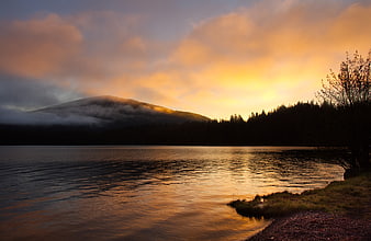 Serene Lake Sunrise with Misty Mountain and Forest Reflection
