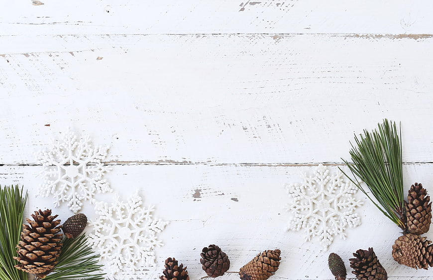 Rustic Christmas Flat Lay with Pine Cones and Snowflakes
