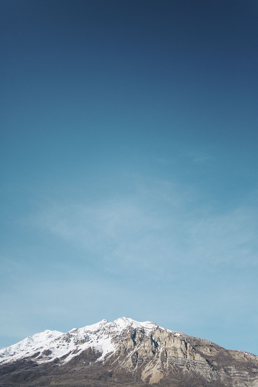 Snow-Capped Mountain Peak Against Clear Blue Sky