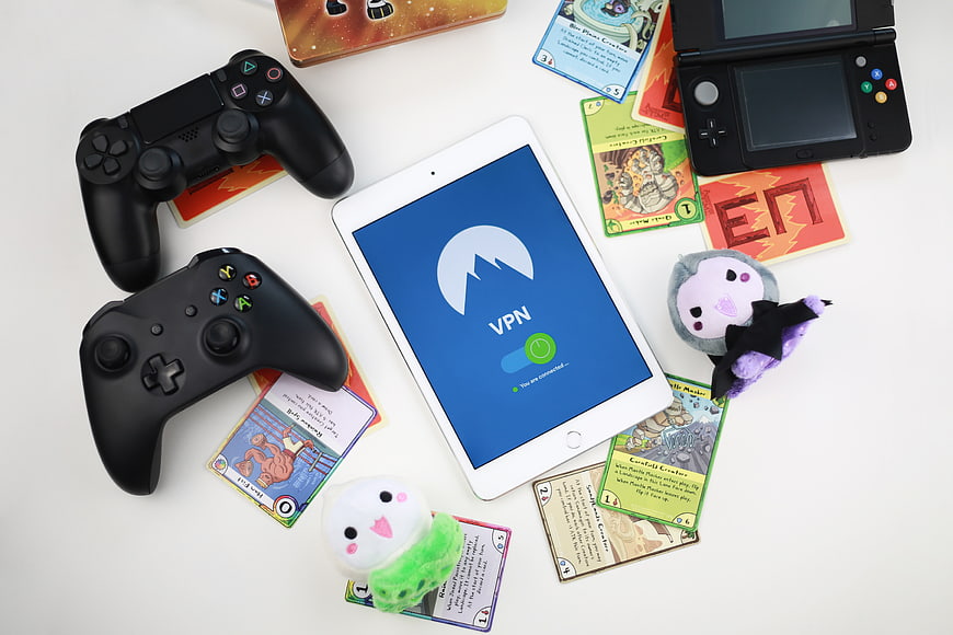 Gaming controllers and tablet with VPN app on white background