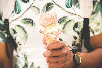 Hand Holding Triple Scoop Ice Cream Cone