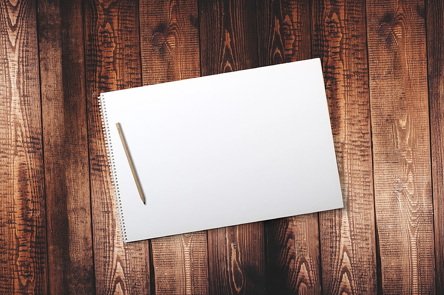 Blank Spiral Notebook and Pencil on Wooden Background