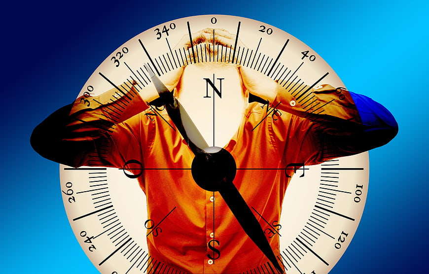 Conceptual double exposure of man and compass symbolizing confusion