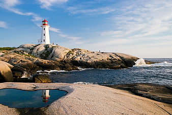 White Lighthouse on Rocky Coast with Tide Pool Reflection