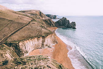 Aerial View of Dramatic Coastal Cliffs and Sandy Beach