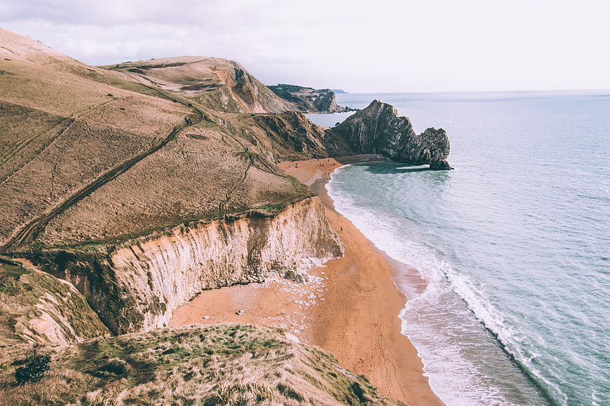 Aerial View of Dramatic Coastal Cliffs and Sandy Beach